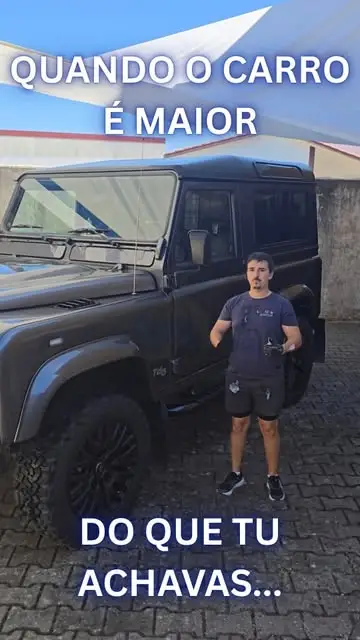 Land Rover Defender preto depois do tratamento, com o detailer ao lado